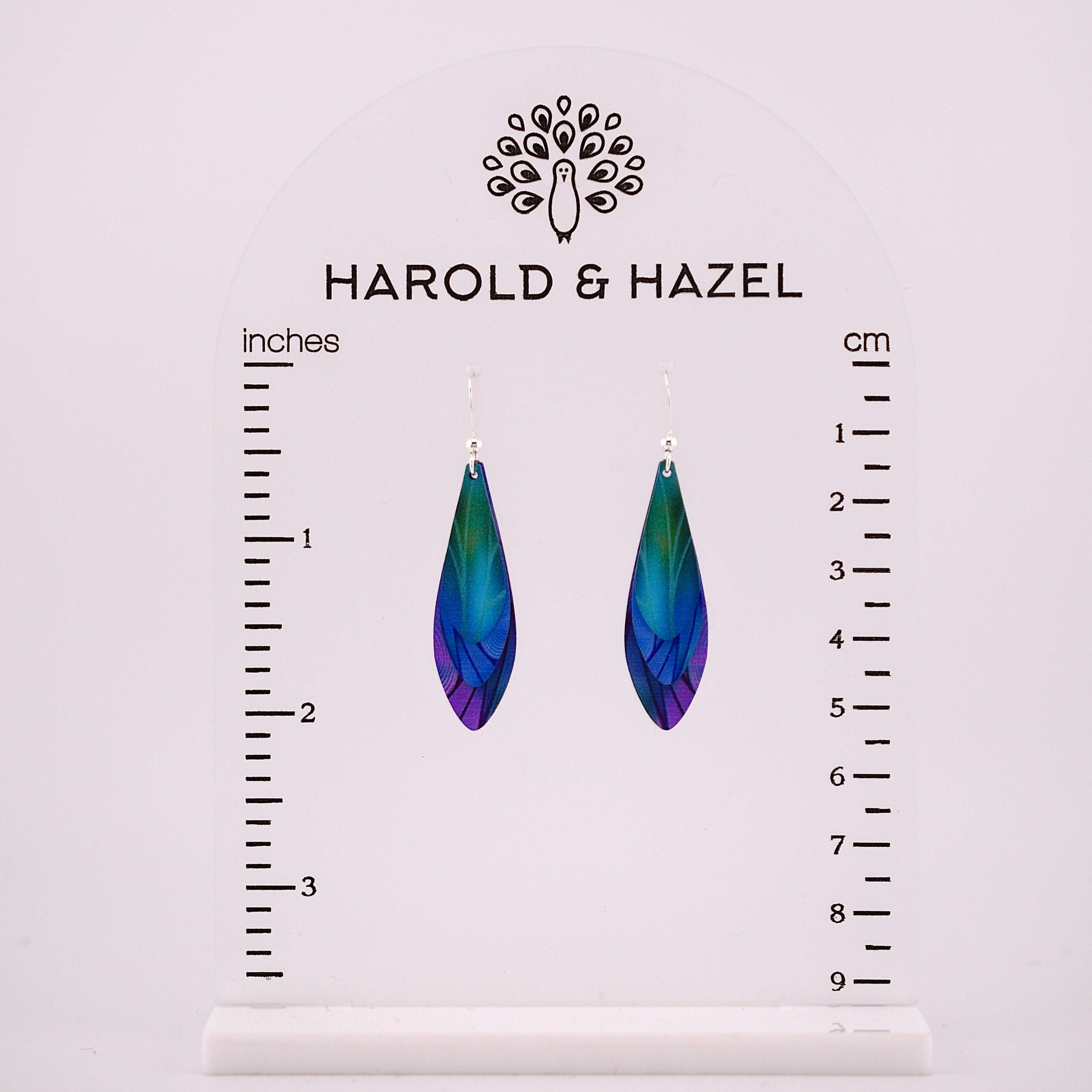 Layered teardrop feather earrings in iridescent blue, green, and purple, made from stainless steel with sterling silver ear wires.
