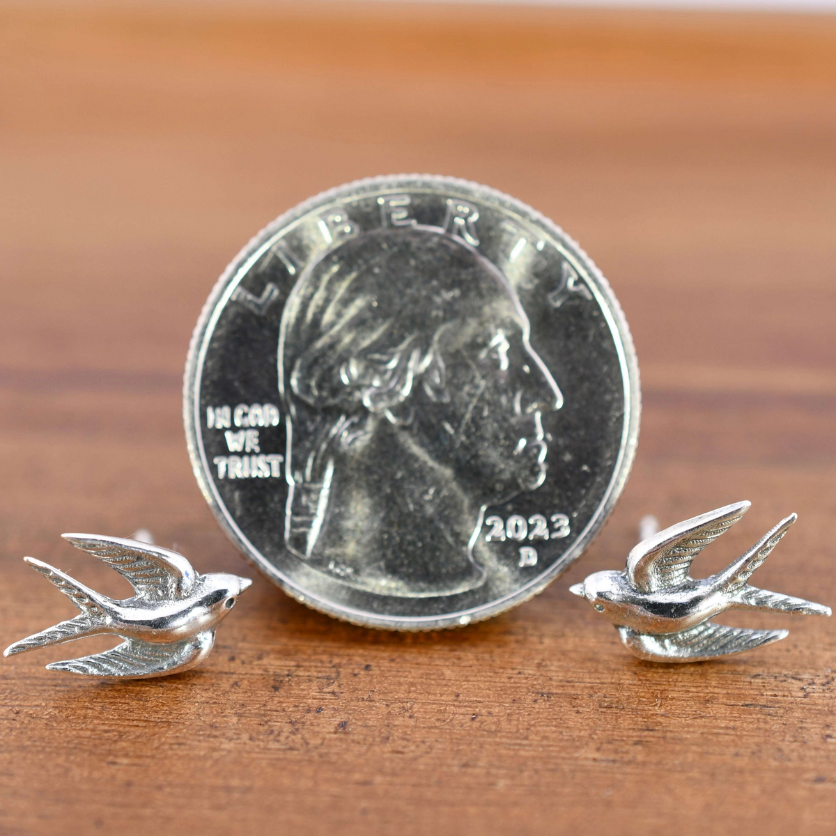 Sterling silver post earrings shaped like swallows in mid-flight, with detailed wings and bodies.