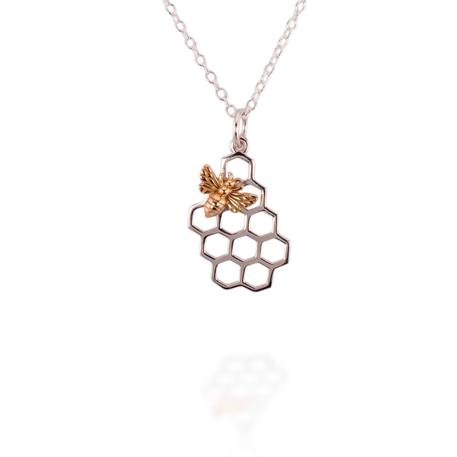 Necklace with a honeycomb and bee pendant on a white background