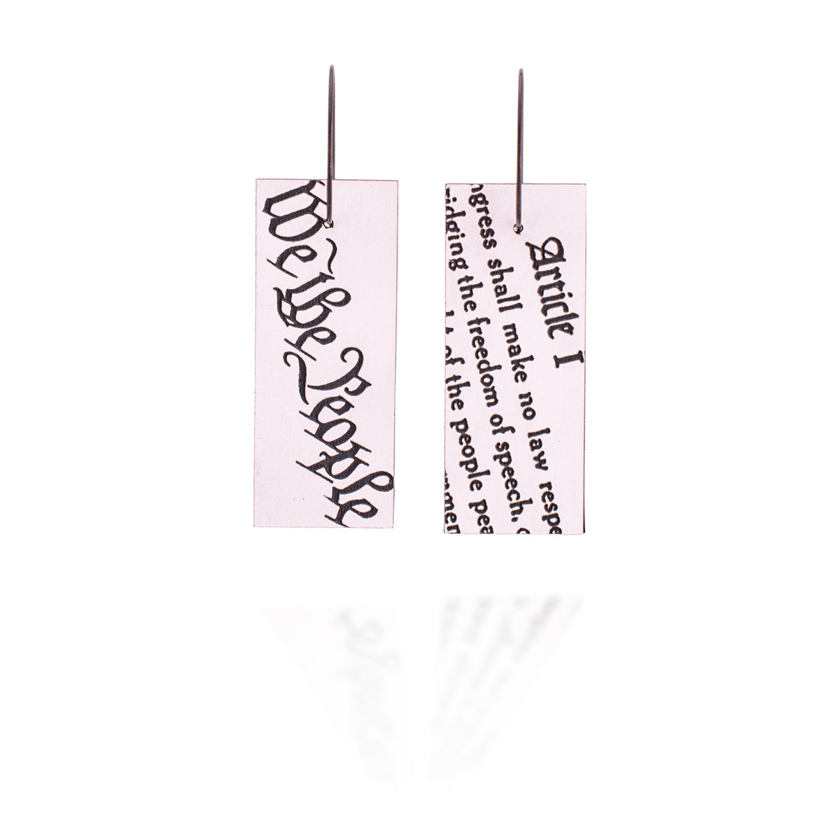 Two earrings with 'We the People' and 'Article I' text on a white background