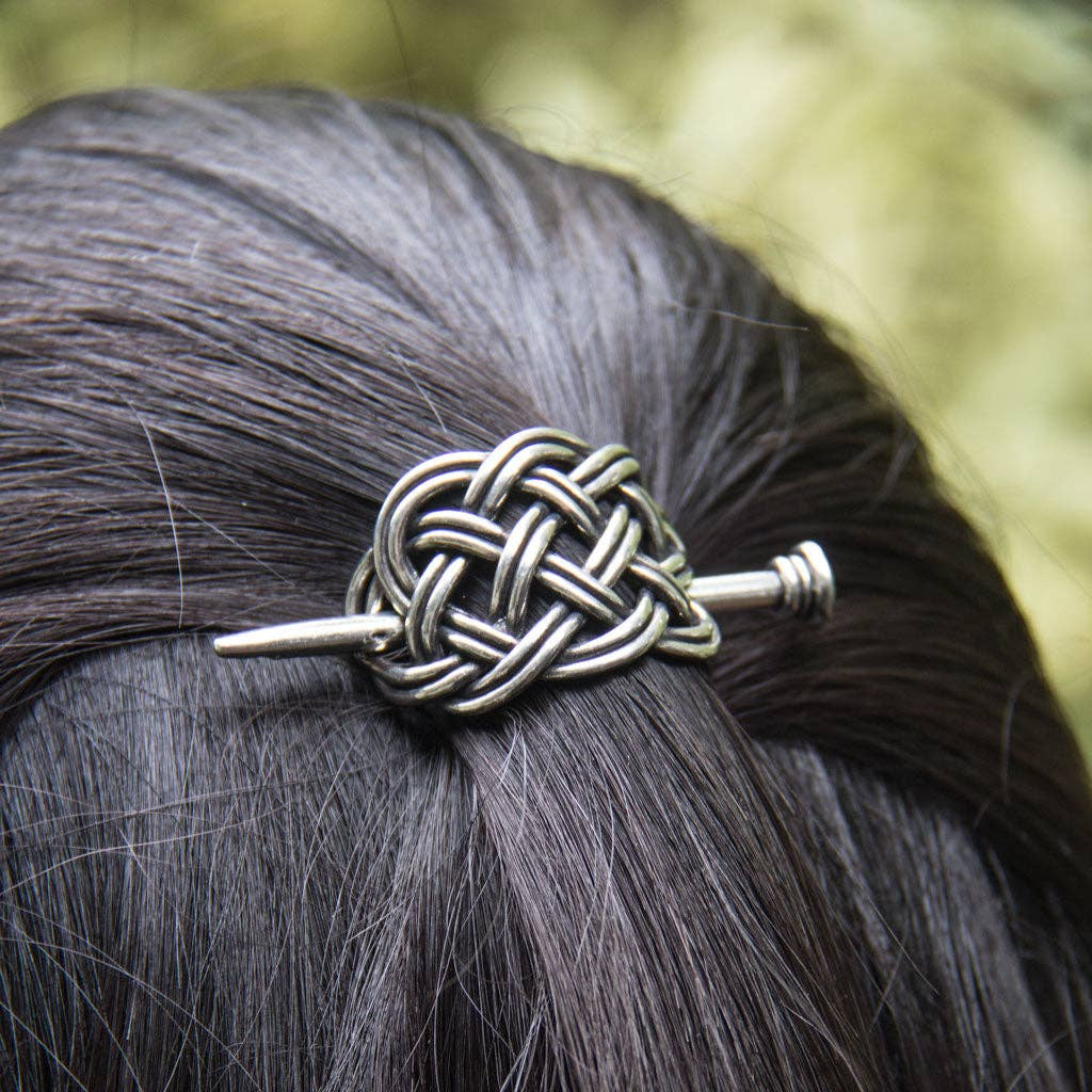 Silver Celtic knot hair stick with a braided design, made of Britannia Metal, for securing buns and up-swept hairstyles.
