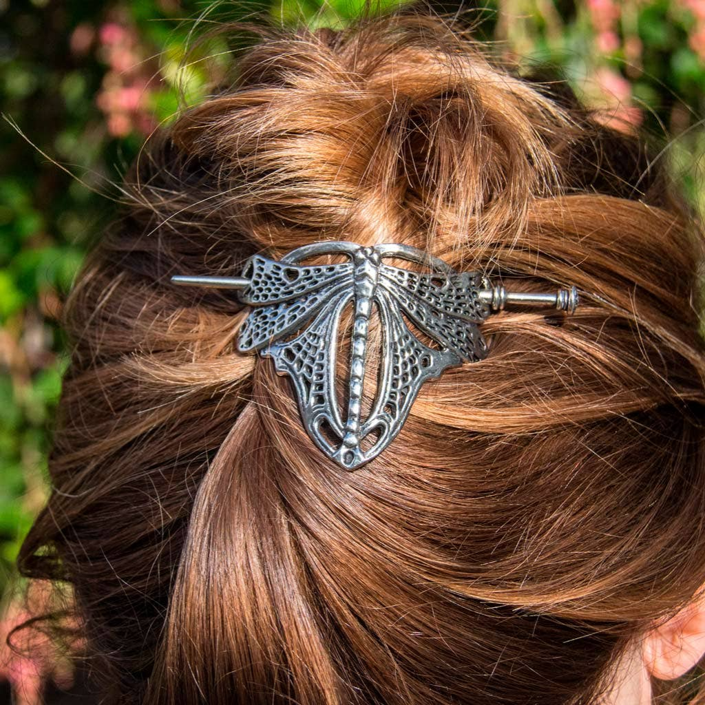 Silver dragonfly hair stick with intricate wing details, securing a brown hair bun. Made from Britannia metal.