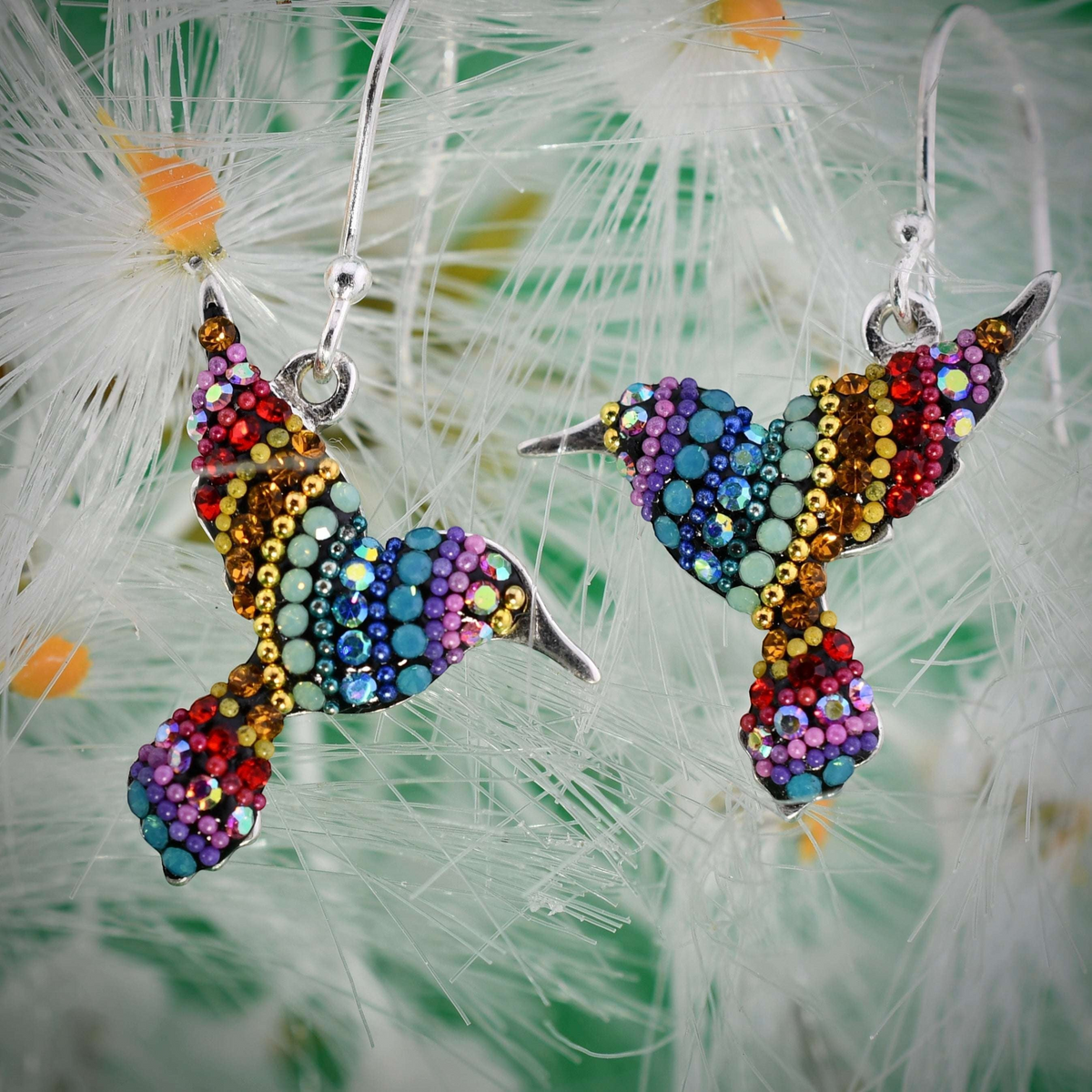 Sterling silver hummingbird earrings encrusted with colorful crystals in a rainbow gradient pattern.